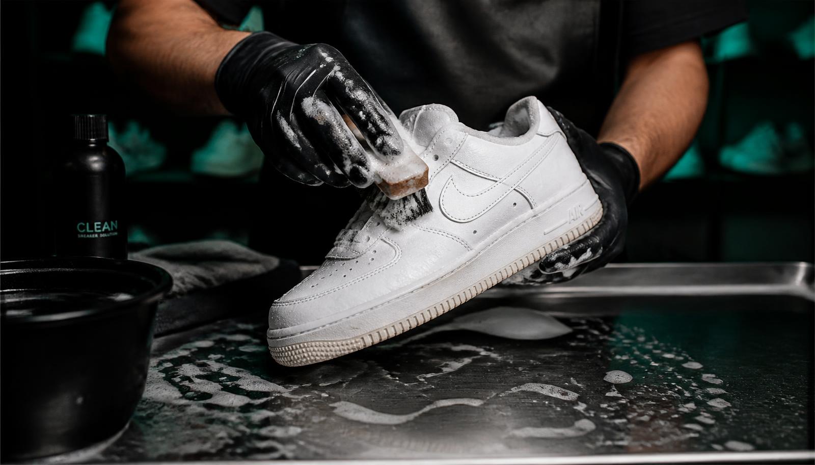 HI-SAVVY founder cleaning a sneaker by hand at the workbench